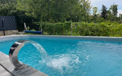 a blue swimming pool with a water spout